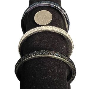 Set of three sliver and Crystal bangle bracelets. One each clear, black, blue.